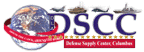 Image: Globe and red banner. Motto, Around the Clock, Around the World. Banner, DSCC in blue with a jet/tank/helicopter/and ship with gold stars